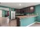 Kitchen with breakfast bar and stainless steel appliances at 12066 Callicarpa Ln, Leesburg, FL 34788