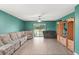 Spacious living room with wood-look floors and a sliding glass door at 12066 Callicarpa Ln, Leesburg, FL 34788
