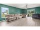 Living area with wood-look floors and sliding glass doors at 12066 Callicarpa Ln, Leesburg, FL 34788
