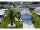 Single-story house with gray roof, driveway and landscaped yard at 1228 Zapata Pl, The Villages, FL 32159