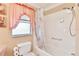 Cozy bathroom featuring a shower-tub combination with a neutral tile surround and window at 1228 Zapata Pl, The Villages, FL 32159
