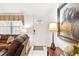 Home entryway with white door and a brown leather couch at 1228 Zapata Pl, The Villages, FL 32159