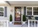 Inviting front entrance with decorative door and potted plants at 1228 Zapata Pl, The Villages, FL 32159