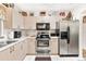 Spacious kitchen with stainless steel appliances, white countertops, and ample cabinet space, perfect for cooking and entertaining at 1228 Zapata Pl, The Villages, FL 32159
