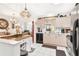 Inviting kitchen with white cabinets, an island, and modern appliances, offering a functional space at 1228 Zapata Pl, The Villages, FL 32159
