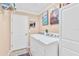 A bright laundry room features a washer and dryer and ample storage space at 1228 Zapata Pl, The Villages, FL 32159
