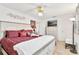 Serene bedroom with an accent wall, stylish furniture, and a bright ceiling fan, offering a relaxing and comfortable atmosphere at 1228 Zapata Pl, The Villages, FL 32159