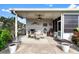 Covered patio with seating area, ceiling fan, and string lights at 1228 Zapata Pl, The Villages, FL 32159