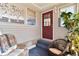 Enclosed porch with seating; features a textured wall, decorative artwork and an exterior door at 1228 Zapata Pl, The Villages, FL 32159