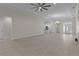 Spacious living room with tile floors and a ceiling fan at 12624 Ne 49Th Dr, Oxford, FL 34484