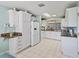 Spacious kitchen with granite countertops and white cabinets at 1310 Landeros Ln, The Villages, FL 32159