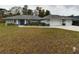 House exterior showcasing a two-car garage and front yard at 15680 Se 84Th Ter, Summerfield, FL 34491