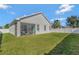 Large backyard with grassy area and screened patio at 15828 Starlite St, Clermont, FL 34714