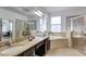 Spa-like bathroom with double sinks, soaking tub and shower at 15828 Starlite St, Clermont, FL 34714