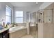 Clean bathroom with large bathtub and separate shower stall at 15828 Starlite St, Clermont, FL 34714