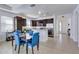 Kitchen and dining area with granite counters and blue chairs at 15828 Starlite St, Clermont, FL 34714