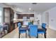 Well-lit dining area adjacent to kitchen, featuring blue chairs at 15828 Starlite St, Clermont, FL 34714