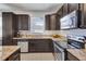 Modern kitchen with stainless steel appliances and granite countertops at 15828 Starlite St, Clermont, FL 34714