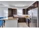 Kitchen with granite countertops, dark cabinets, and stainless steel appliances at 15828 Starlite St, Clermont, FL 34714