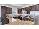 Modern kitchen with granite countertops and dark wood cabinets at 15828 Starlite St, Clermont, FL 34714