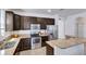 Spacious kitchen featuring dark wood cabinets and granite countertops at 15828 Starlite St, Clermont, FL 34714