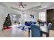 Cozy living room with blue sofa and sliding glass doors to the backyard at 15828 Starlite St, Clermont, FL 34714