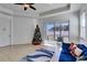 Living room with blue sofa, Christmas tree, and access to patio at 15828 Starlite St, Clermont, FL 34714