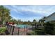 Community pool with patio furniture and lush landscaping at 15828 Starlite St, Clermont, FL 34714