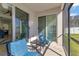 Cozy screened porch with glass sliding doors and outdoor furniture at 15828 Starlite St, Clermont, FL 34714