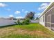 Private backyard with screened patio, grassy area, and white vinyl fence at 15836 Starlite St, Clermont, FL 34714