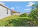 Private backyard with screened patio, grassy area, and white vinyl fence at 15836 Starlite St, Clermont, FL 34714