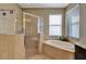 Large bathroom with walk-in shower, soaking tub and a window at 15836 Starlite St, Clermont, FL 34714