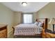 Well-lit bedroom with a full-size bed and wood furniture at 15836 Starlite St, Clermont, FL 34714