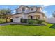 Two-story house with a white exterior, landscaping, and a two-car garage at 15836 Starlite St, Clermont, FL 34714