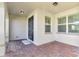 Brick paved front porch with black front door and sidelights at 15836 Starlite St, Clermont, FL 34714