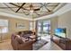 Gathering room features tray ceiling, sliding glass doors to the patio and plenty of natural light at 15836 Starlite St, Clermont, FL 34714