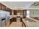 U-shaped kitchen with granite counters, stainless steel appliances, and ample cabinet space at 15836 Starlite St, Clermont, FL 34714