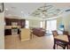 Open kitchen with dark cabinetry, granite counters, and stainless steel appliances at 15836 Starlite St, Clermont, FL 34714
