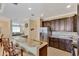 Modern kitchen features granite countertops and dark wood cabinets at 15836 Starlite St, Clermont, FL 34714