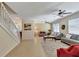 Spacious living room with two sofas, a coffee table, and ceiling fans at 15836 Starlite St, Clermont, FL 34714