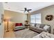 Bright living room with neutral walls, comfy sofas, and a ceiling fan at 15836 Starlite St, Clermont, FL 34714