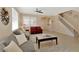 Living area showcasing a staircase, neutral colors, and comfy seating at 15836 Starlite St, Clermont, FL 34714