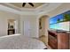 Spacious main bedroom with ensuite bathroom and large TV at 15836 Starlite St, Clermont, FL 34714