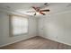 Well-lit bedroom with window blinds and wood flooring at 1701 Magnolia Ave, The Villages, FL 32159