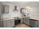 Renovated kitchen featuring modern appliances and granite countertops at 1701 Magnolia Ave, The Villages, FL 32159