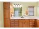 Bathroom with double vanity and a large mirror at 17112 Se 71St Lewisfield Ter, The Villages, FL 32162