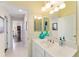 Bright bathroom with vanity, mirror, and access to another room at 17112 Se 71St Lewisfield Ter, The Villages, FL 32162