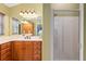 Bathroom with double vanity and a walk-in shower at 17112 Se 71St Lewisfield Ter, The Villages, FL 32162