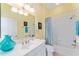 Small bathroom with a single vanity, tub, and shower at 17112 Se 71St Lewisfield Ter, The Villages, FL 32162