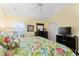 Bedroom with floral bedding, dark wood furniture, and a TV at 17112 Se 71St Lewisfield Ter, The Villages, FL 32162